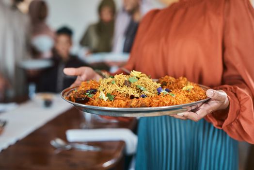 This is my favourite dish. a muslim woman holding a plate of food.