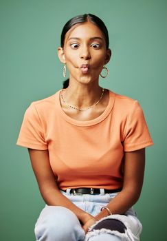 Im so quirky. a woman making a funny face shot against a studio background.