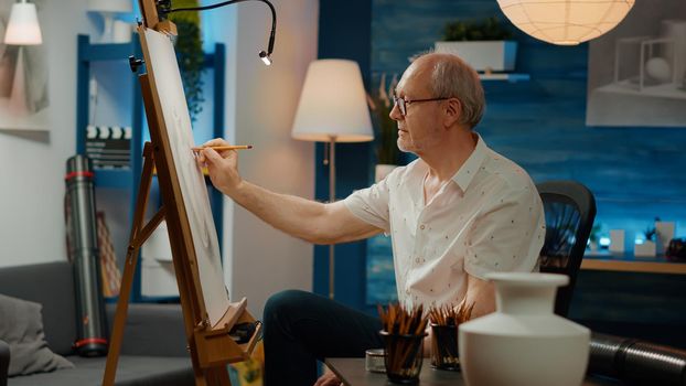 Retired adult looking at vase inspiration to draw artwork sketch