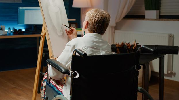 Wheelchair user drawing professional masterpiece for hobby