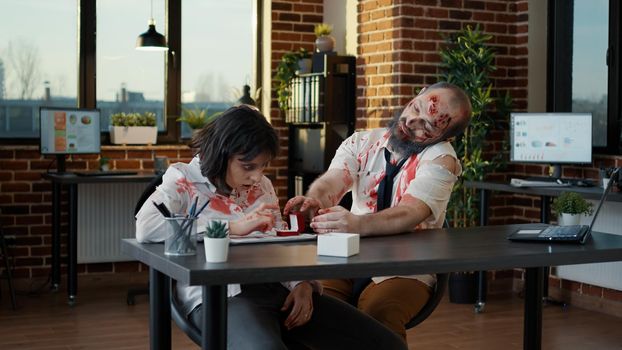 Romantic undead creepy zombie with deep bloody wounds proposing to mindless disgusting girlfriend.