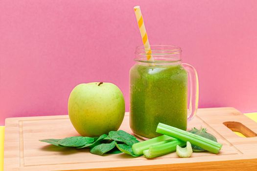 Fresh Green Smoothie of Apple, Celery, and Spinach in Glass Smoothie Jar