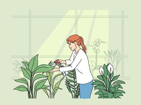 Woman watering plants at home