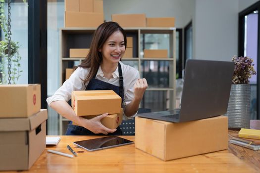 Attractive Asian entrepreneur business woman excited while order come