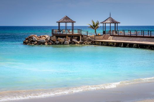 Tropical paradise: caribbean beach with pier and gazebo, Montego Bay, Jamaica