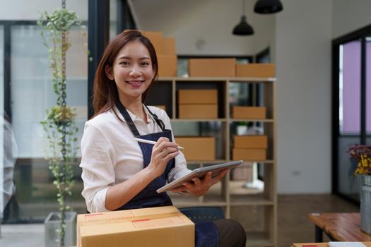 Attractive Asian entrepreneur business woman look at camera