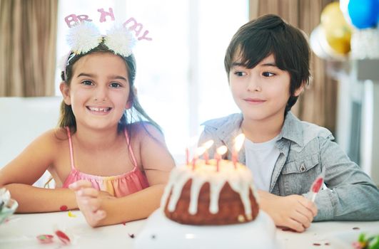 A birthday is only one of the things we share. a young boy and girl celebrating a birthday together.