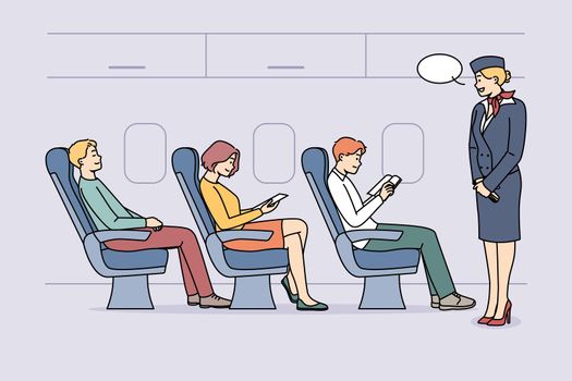 Stewardess talking with passengers on plane