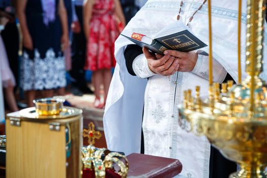 Orthodox religion. Hands of the priest on the bible.