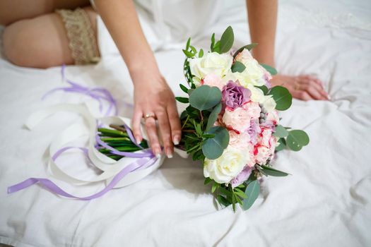 Wedding bouquet in the hands of the newlywed