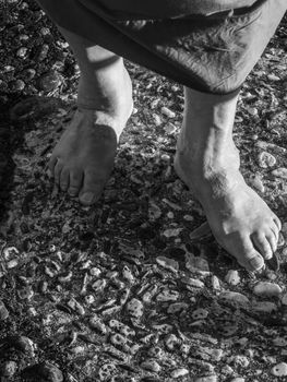 senior woman feet on pebbles floor outdoors
