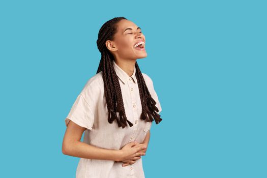 Woman with black dreadlocks laughing out loud, hearing funny joke, expressing positive,