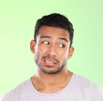 I dunno... a handsome young man making a face against a green background in studio.