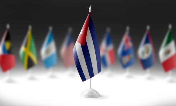 The national flag of the Cuba on the background of flags of other countries