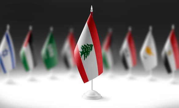 The national flag of the Lebanon on the background of flags of other countries
