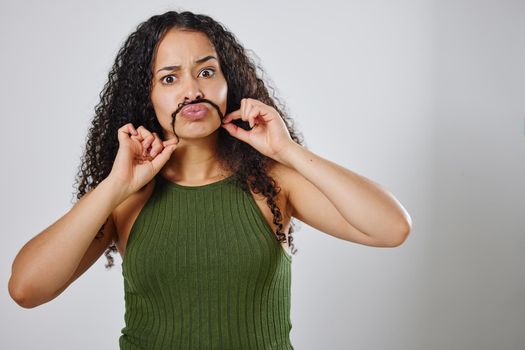 Life is too short for boring hair. a woman making a moustache with her hair.