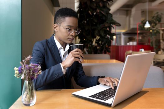 Serious and focused business woman working in a hotel restaurant, African American woman