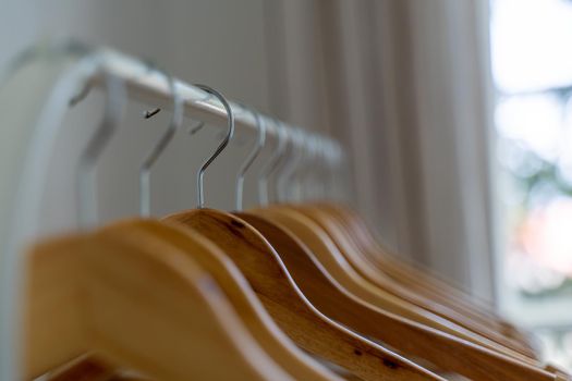 Close-up of wardrobe with wooden clothes hanger,
