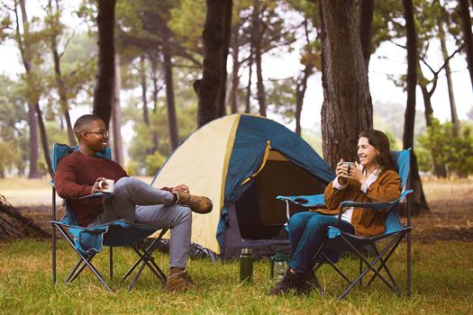 Nature is the perfect place to bond. a young couple camping in the wilderness.
