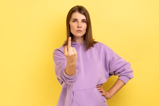 Woman showing middle fingers, impolite gesture of disrespect, looking with aggression hate.