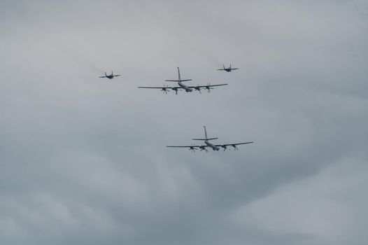 Russia, St. Petersburg, 28 July 2022: Military aircraft and helicopters of the air force fly on the city at the celebration of the Day of the Navy, amphibious and transport aircraft, anti-submarine