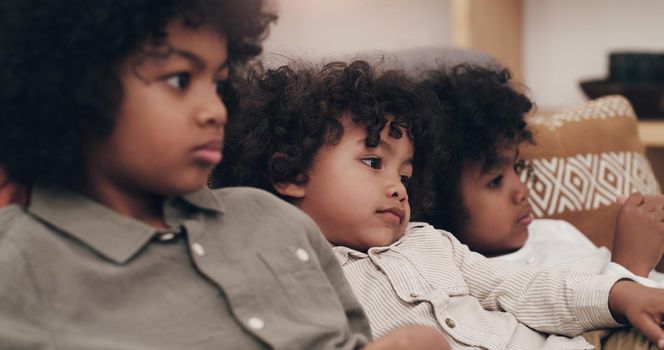 This movie has us hooked. three adorable little boys watching movies together at home.