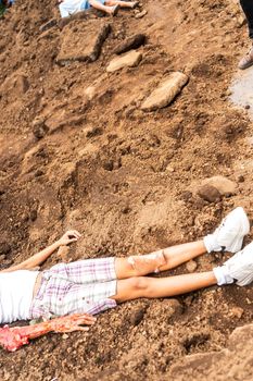 Unrecognizable Latin woman victim of femicide lying in a pile of dirt