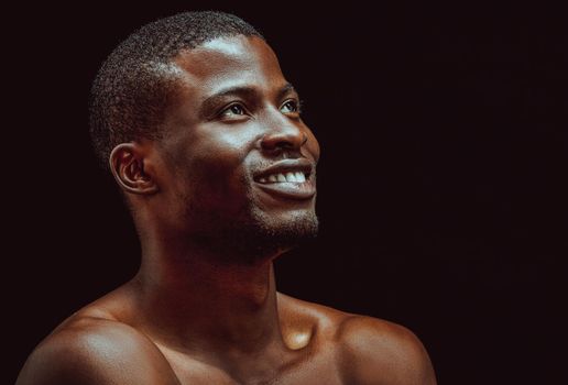 Black african man smile studio in beautiful style on black background. Black background. Isolated studio portrait. Beautiful model