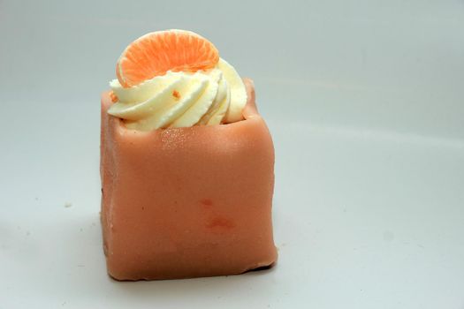 Pink Marzipan confectionery with decorative piece of fruit