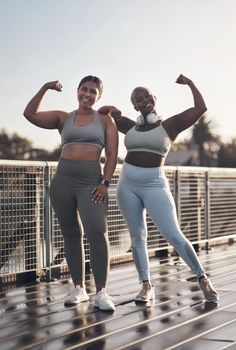 Do more of what makes you feel more confident. two young women flexing while out for a run.