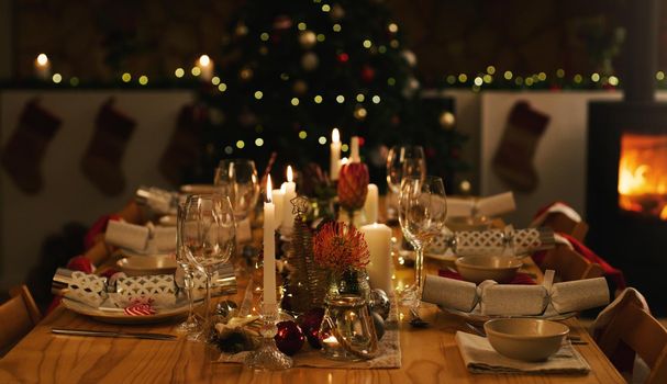 Come celebrate Christmas with us. a neatly arranged dinner table and Christmas tree ahead of a family Christmas dinner at home.