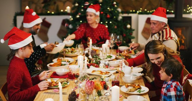 Theres a special kind of togetherness that only Christmas can bring. a happy family having Christmas lunch together at home.