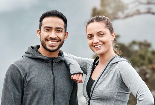 We regularly hit the trails together. Portrait of a sporty young man and woman exercising outdoors.