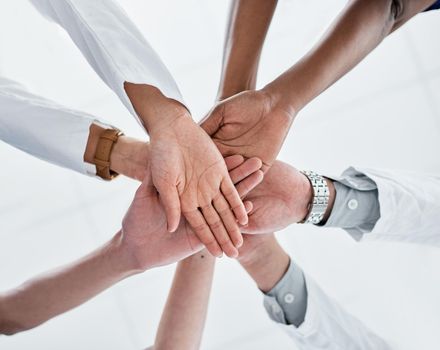 Joining together for the sake of quality healthcare. Closeup shot of a group of medical practitioners joining their hands together in a huddle.