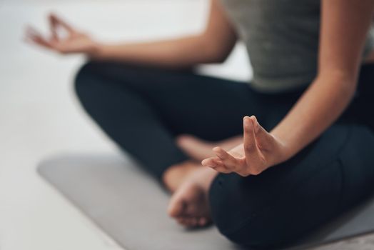 Stay focused on the good. an unrecognisable woman meditating in the lotus position