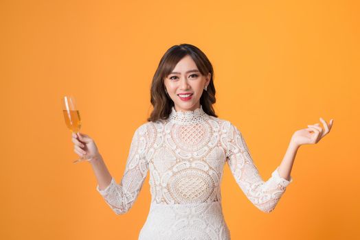Young beautiful sexy woman in white fashion dress drinking alcohol cocktail