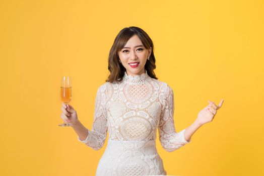 Young beautiful sexy woman in white fashion dress drinking alcohol cocktail