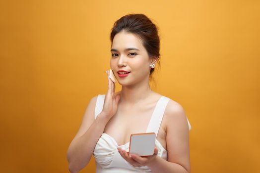 Closeup Of Beautiful Asian Woman With Cushion Puff And Mirror Applying Makeup Powder Foundation