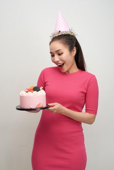 Girl with birthday cake on a white background