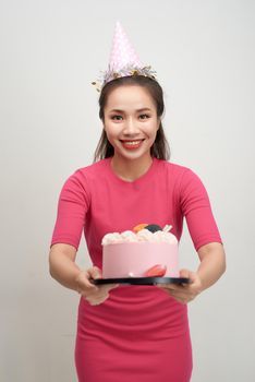 Asian birthday girl looking at camera with smile. 