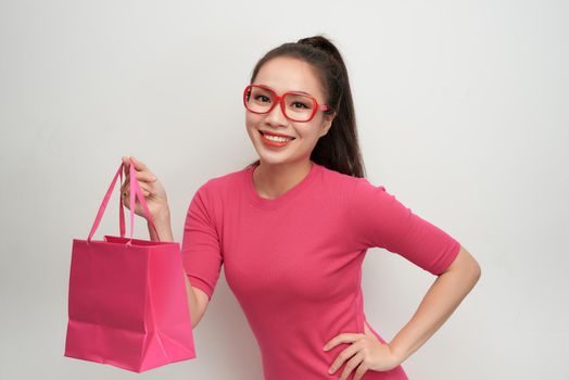 Trendy young girl with shopping bags on white background