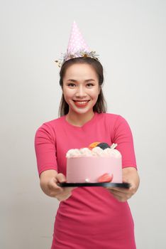 Asian birthday girl looking at camera with smile. 