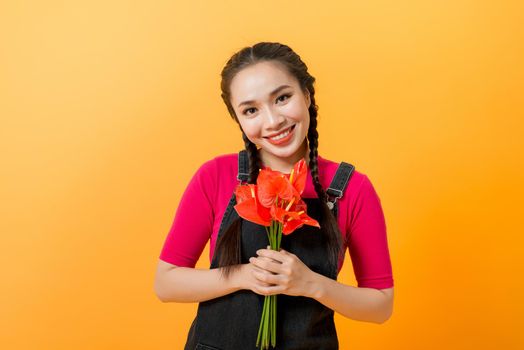 Beauty woman Asian cute girl feel happy holding bouquet of flowers on yellow background - lifestyle beautiful woman