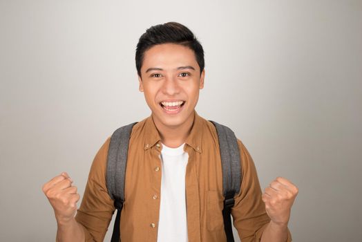 An excited student with his hands up when he passed the exam