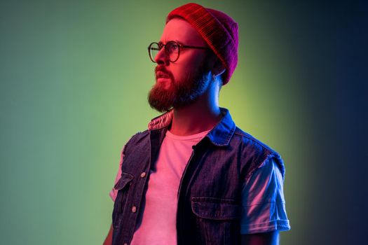 Pensive attractive hipster man with beard looking away, beauty, fashion portrait.