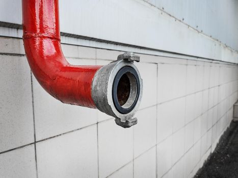 Red fire-fighting pipeline with a close-up lock