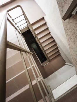 A flight of stairs with steps and handrails from top to bottom