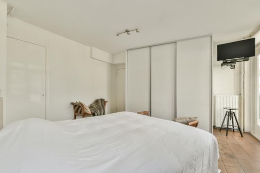 Wide bed in light bedroom