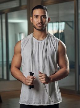 Skipping is a great form of cardio. Cropped portrait of a handsome young male athlete standing with a skipping rope in the gym.