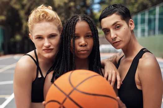 Staying focused on the game. Portrait of a group of sporty young women standing together on a sports court.